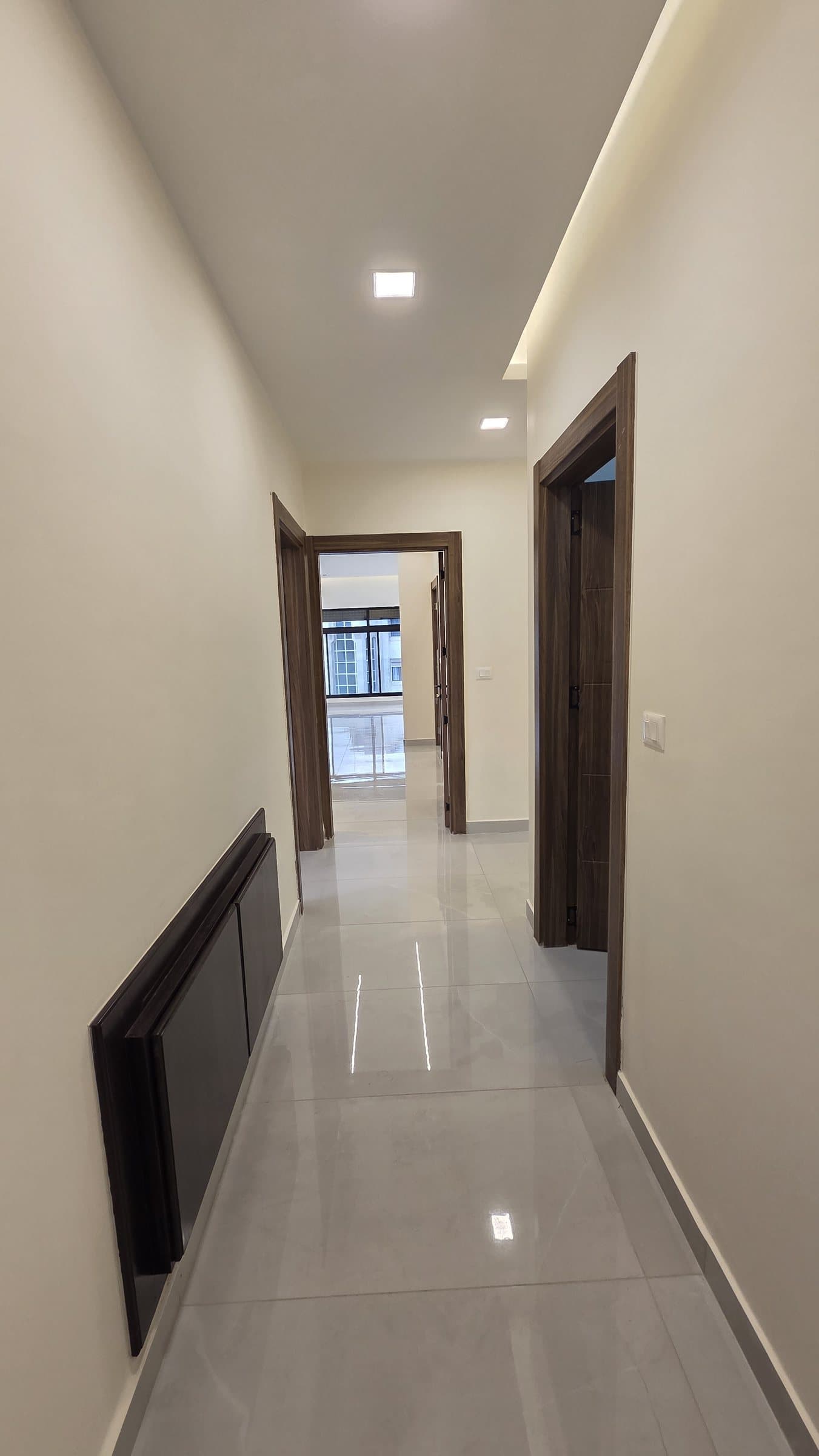 Residence 201 — Corridor to Storage room on right, third bedroom on left, main bedroom ahead