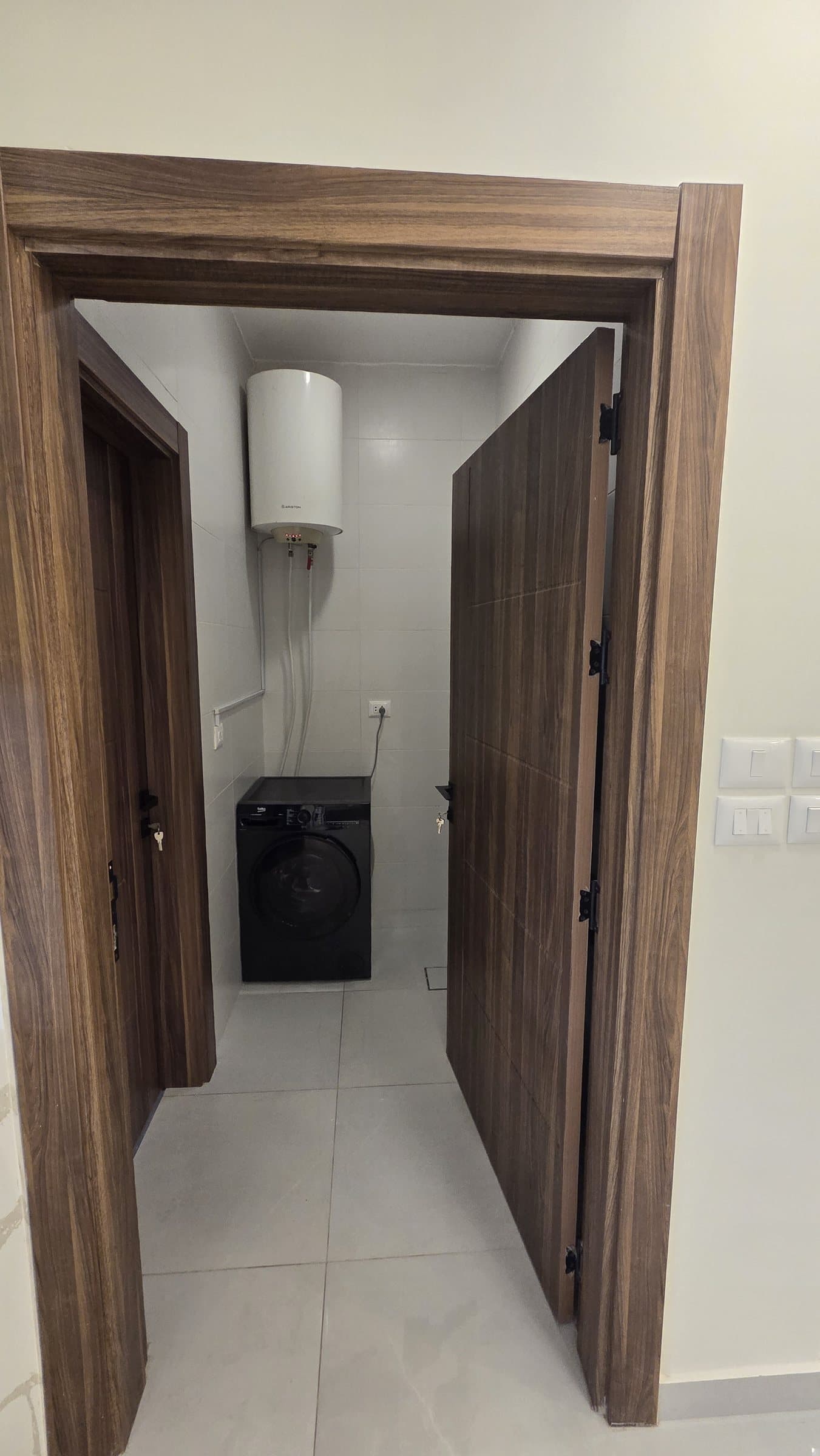 Residence 201 — Laundry Room and access to maids room with private bathroom