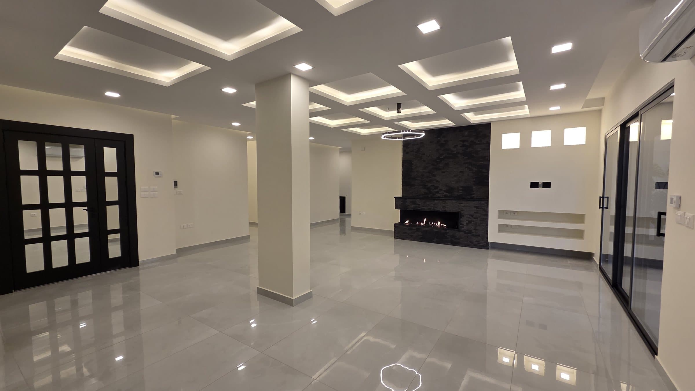 Residence 201 — Living Room showing entrance on left and fireplace at front