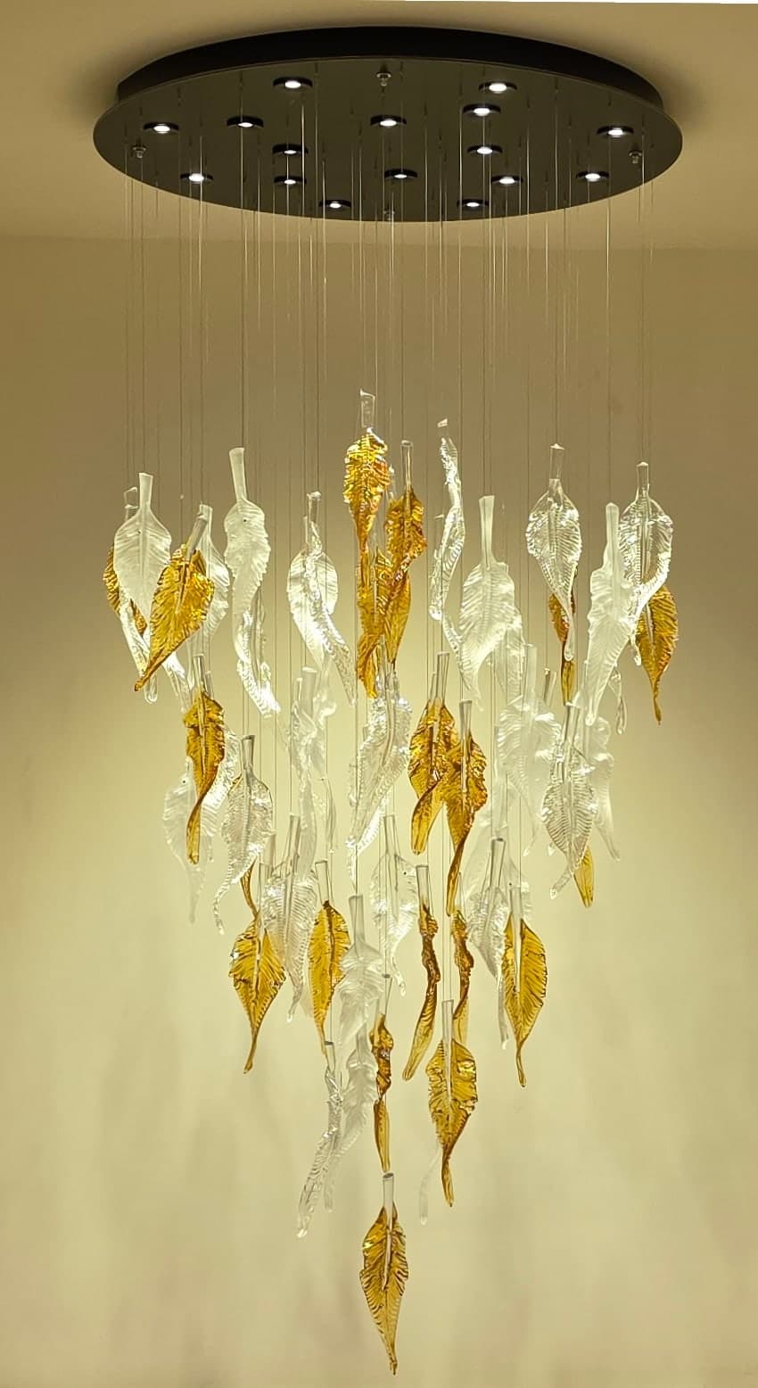 Full portrait of the rooftop chandelier cascading through the high-ceiling landing