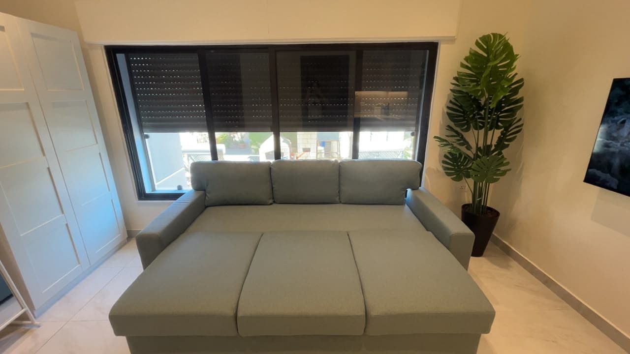Residence 303 quality sofa bed lowered into sleeping position by the window
