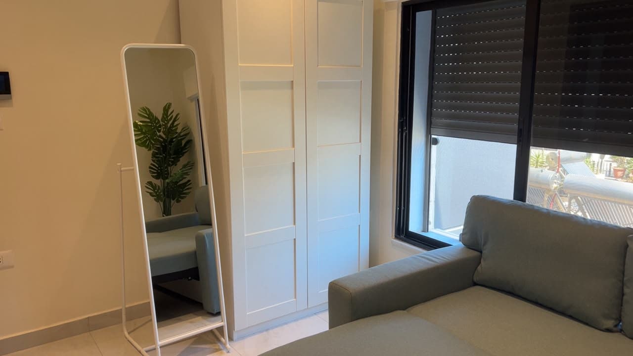 Residence 303 fitted wardrobe with dressing mirror beside the window