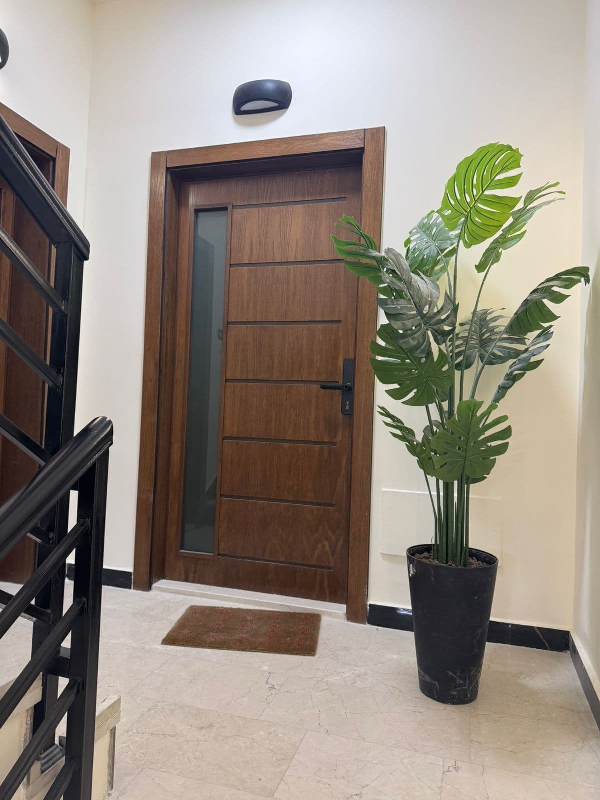 Residence 101 walnut entrance door with frosted glass