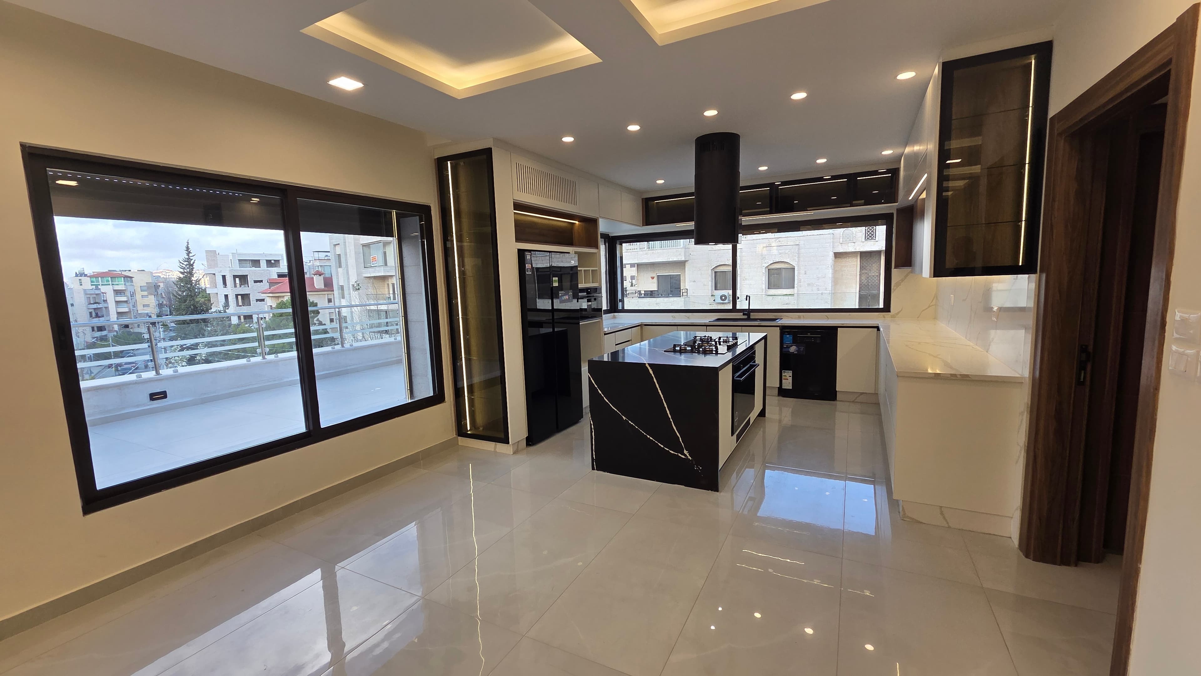 Residence 201 living room with open kitchen and terrace views